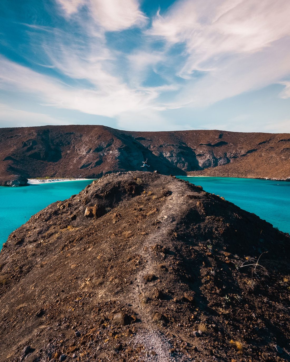 Looking down from a desert ridge onto the turquoise water of Balandra Bay