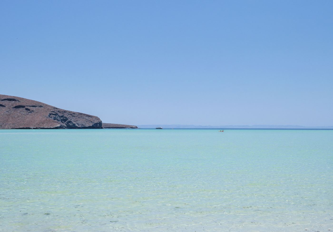 Clear turquoise water at Playa Balandra with a kayak in the distance