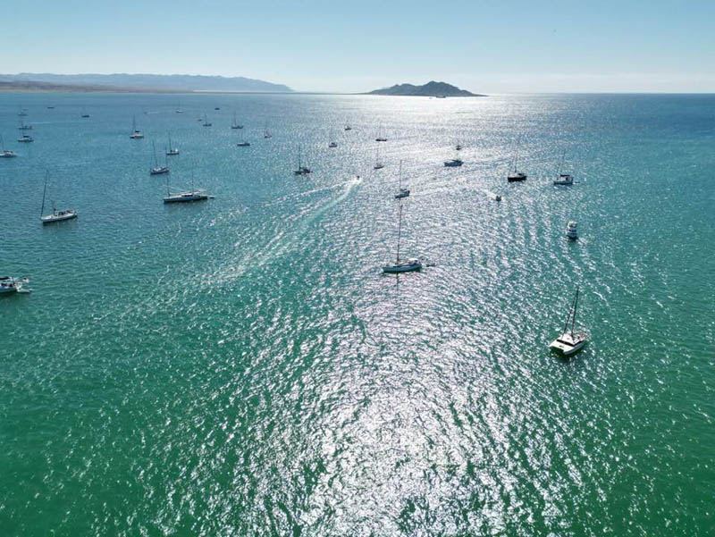 Boats anchored in the bay off La Paz, an island on the horizon