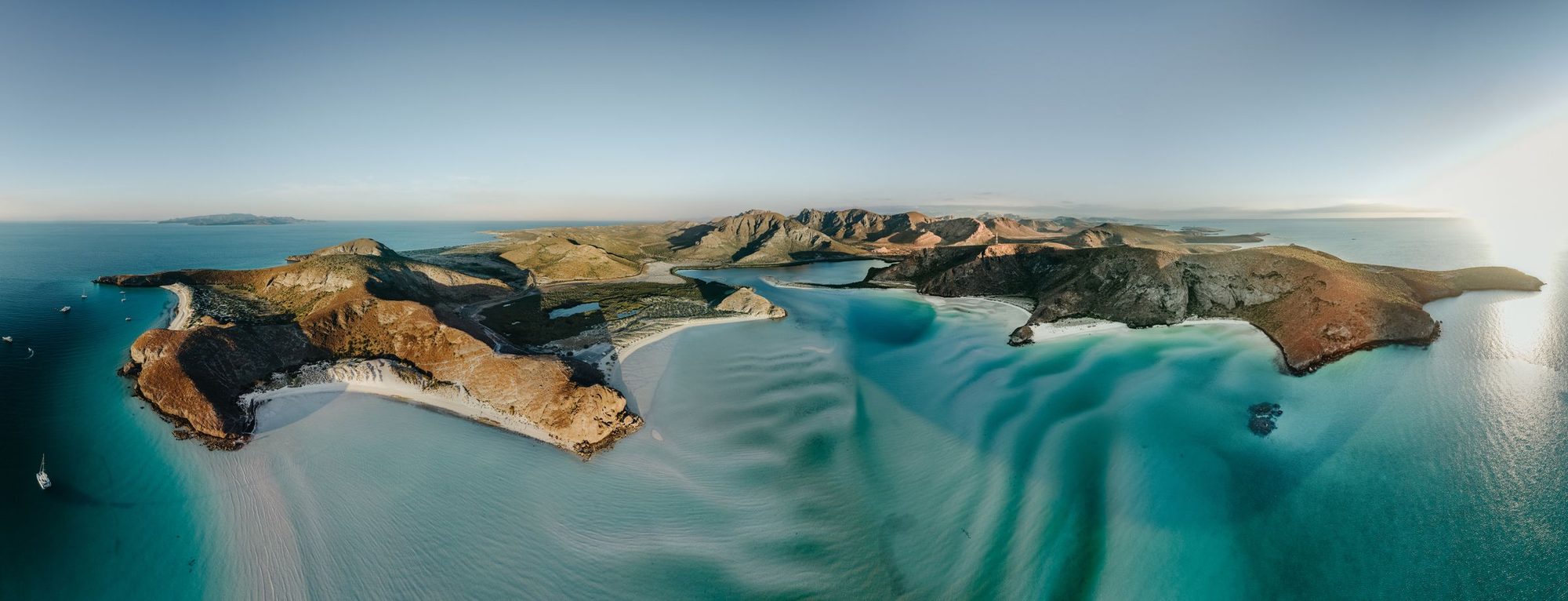 Aerial view of Isla Espíritu Santo, red rock and white sand above turquoise shallows
