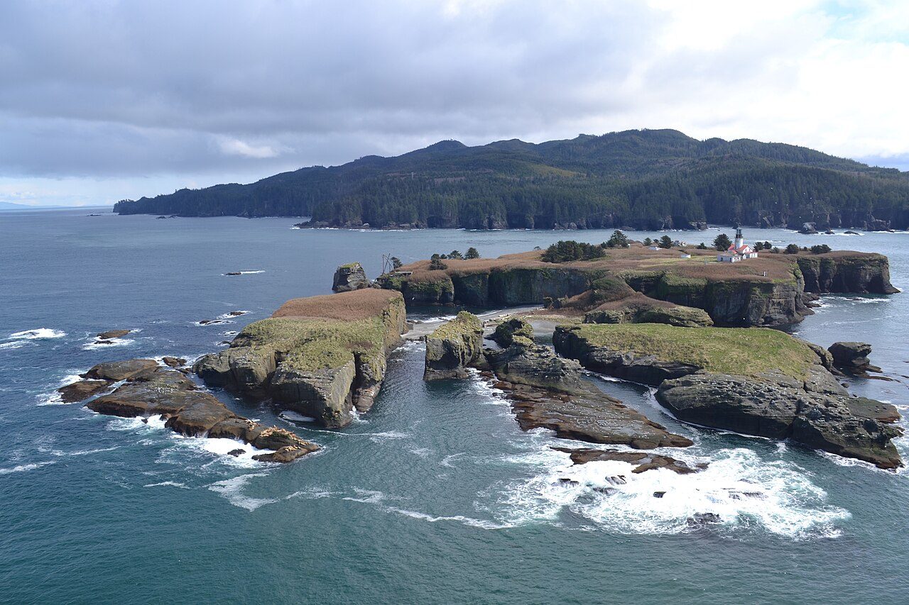 Tatoosh Island and its lighthouse off Cape Flattery, surf on the rocks